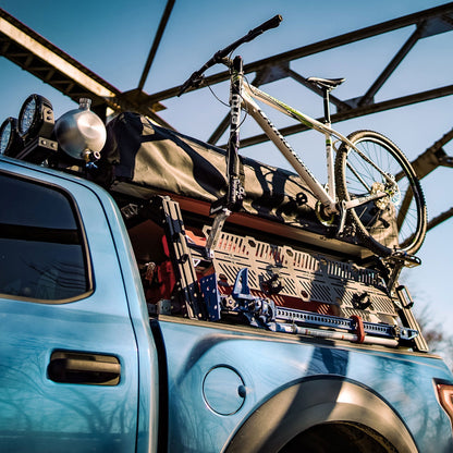 Ford Raptor Extrusion Overland Bed Rack with Hi-lift mounted, Rotopaxâ€™s mounted, Molle panels, Mountain Bike, Roof top tent, and Pressurized solar water tank.